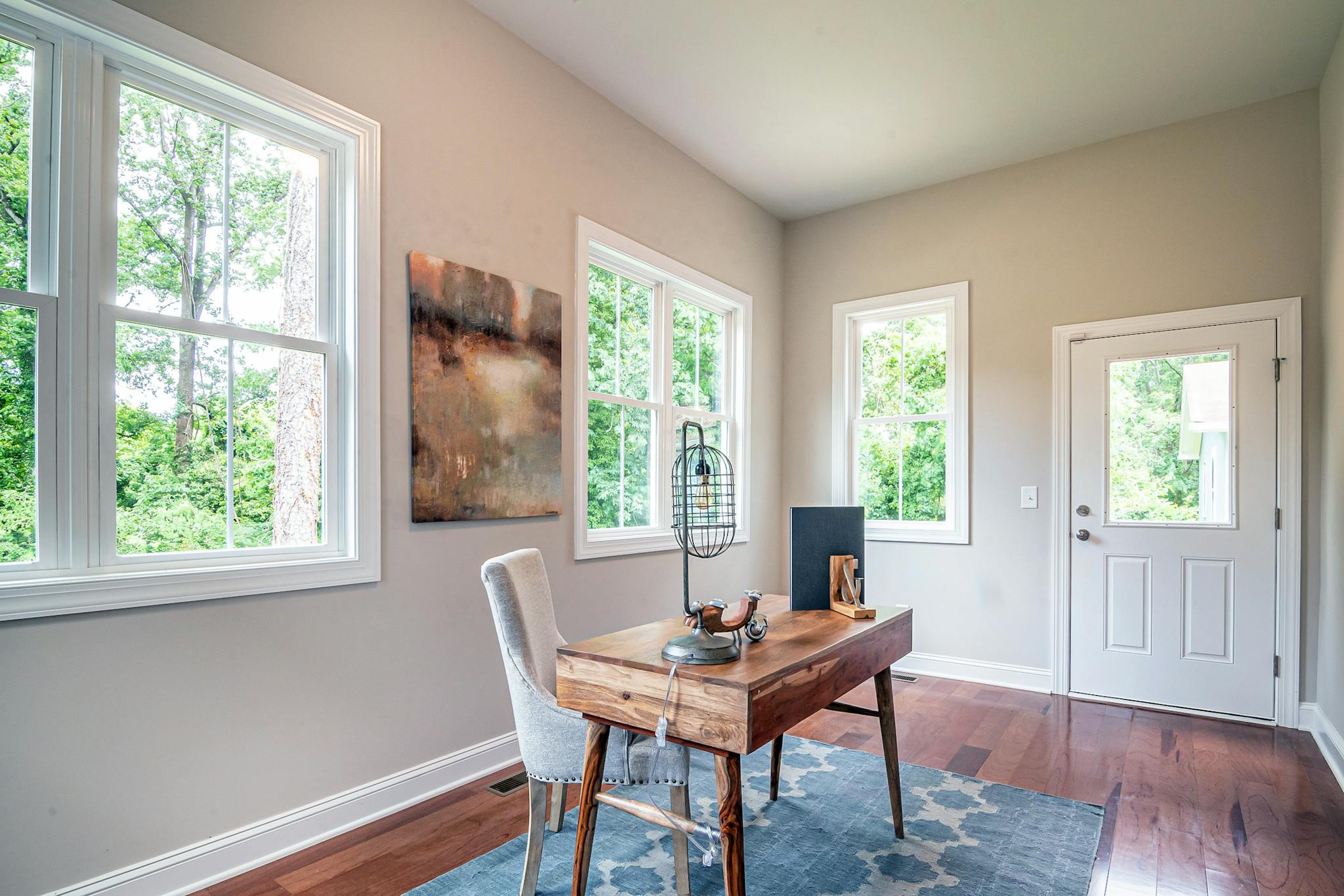 A well-lit, minimalist home office with modern furniture and decor.